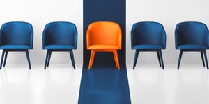 An orange Chair That Stands Out From the other Chairs