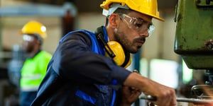 professional engineer Industrial workers wearing safety hats in a warehouse or factory setting.